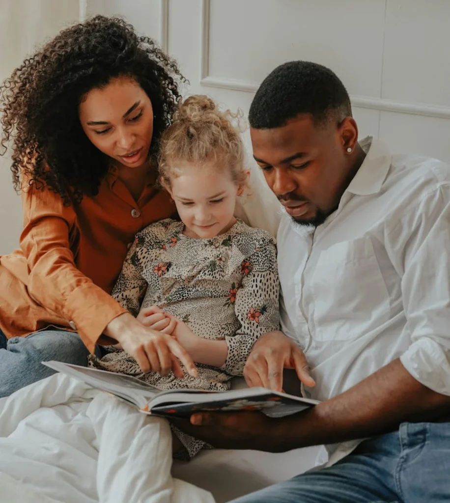 adoptive family reads a book together