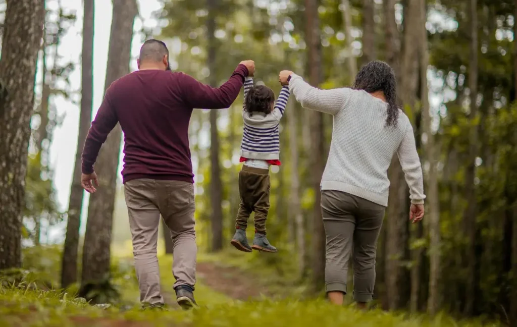 Parents raise their children off the ground playing